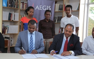 Freddy Mutanguha of the Aegis Trust signs MoU with Ambassador Mussie Hailu for URI Africa