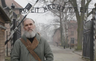 David Wilkinson at Auschwitz in the documentary Getting Away with Murder(s)