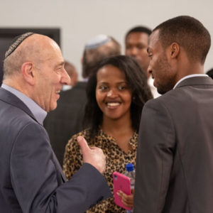Holocaust survivor Emil Fish chats with Rwandan students after giving his testimony