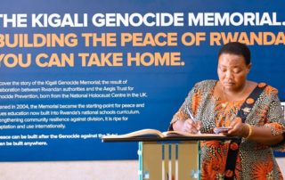 Hon. Robinah Nabbanja, Prime Minister of Uganda, writes a message in the visitors book at the end of her visit to the Kigali Genocide Memorial