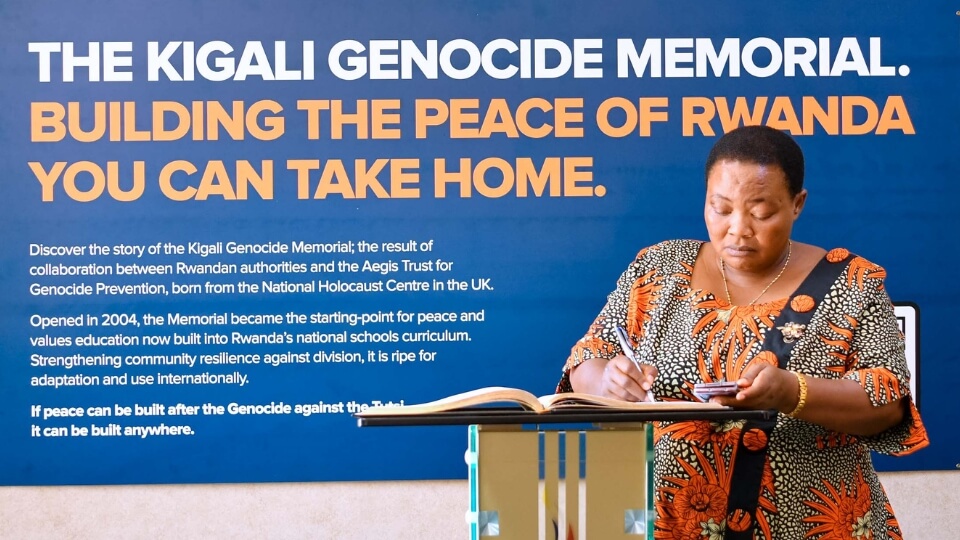 Hon. Robinah Nabbanja, Prime Minister of Uganda, writes a message in the visitors book at the end of her visit to the Kigali Genocide Memorial